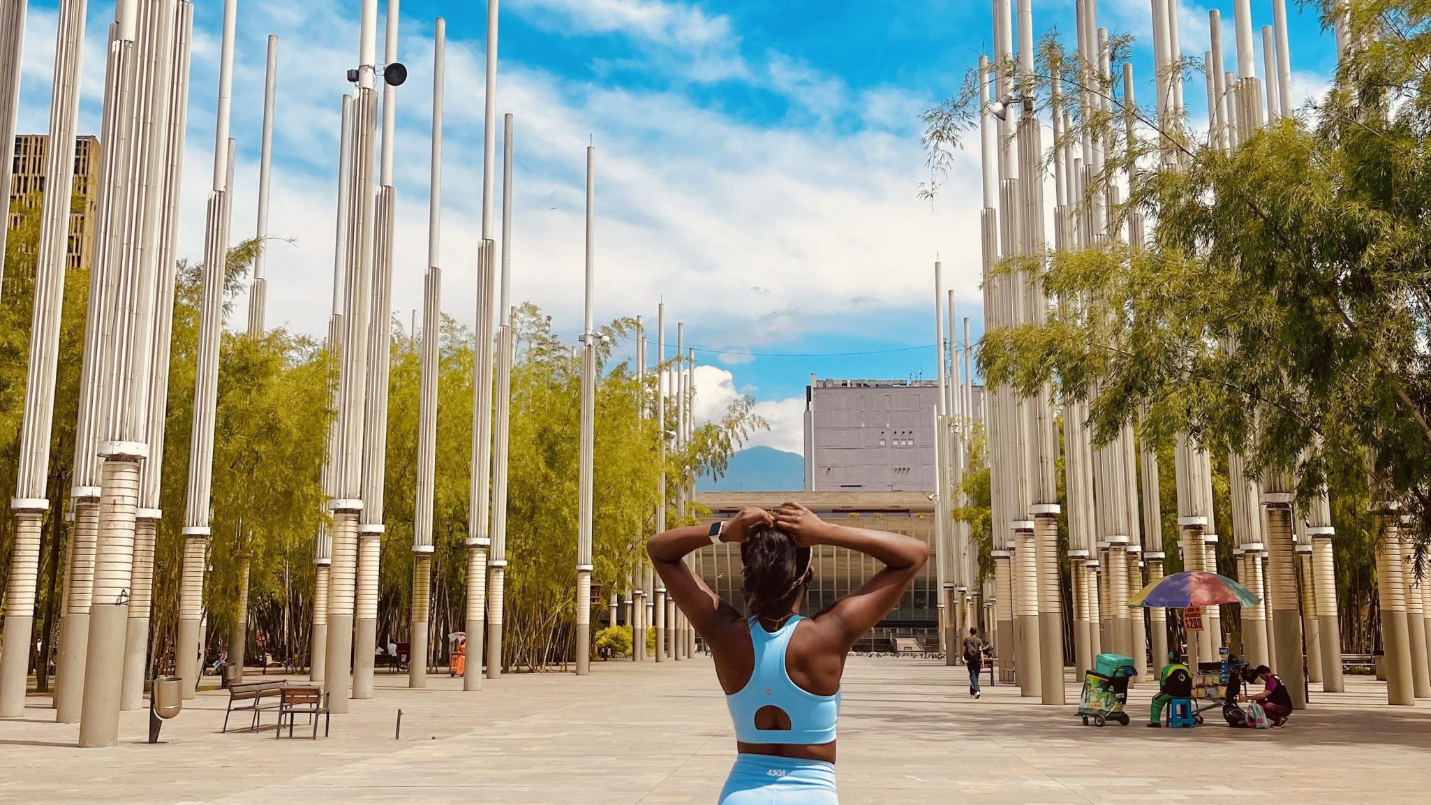 Girl in blue staring into the streets of Bogota on a solo trip