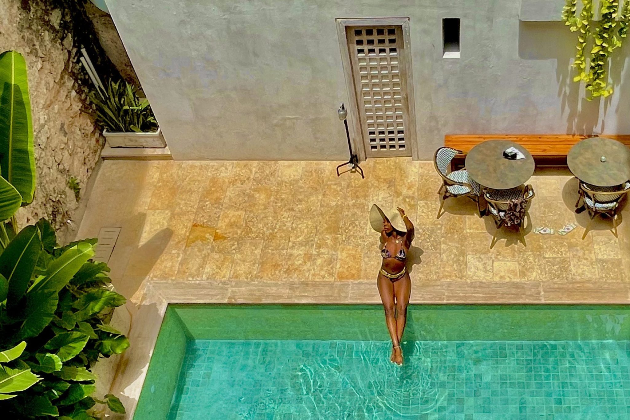 Girl sitting at the edge of a pool in Cartagena, Colombia