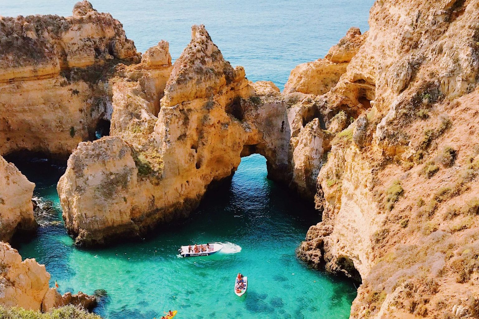 Stunning aerial view of cliffs and clear blue water at Lagos, Portugal, showcasing natural beauty.