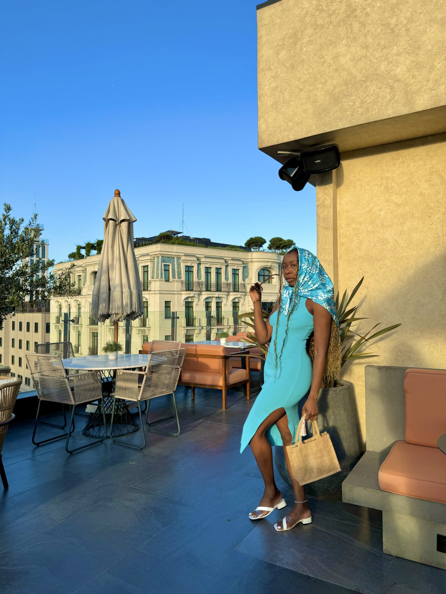 Girl wearing Blue dress standing on the The wings Hotel Rooftop in Istanbul Turkey