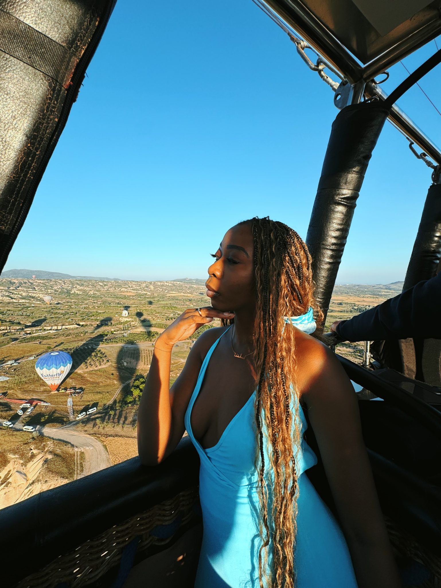 Girl wearing blue dress in a Cappadocia air balloon