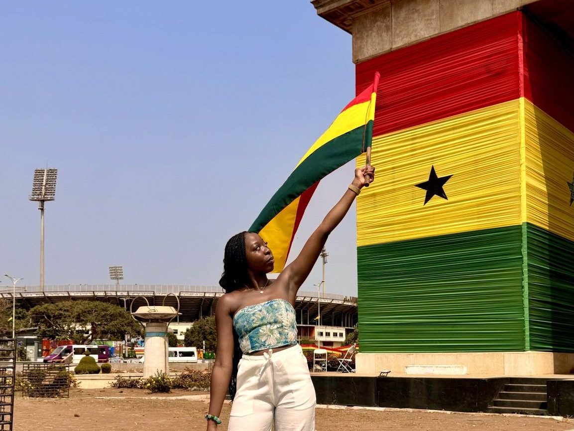 Girl holding a flag in Accra, Ghana, Indepedence Black Star Square