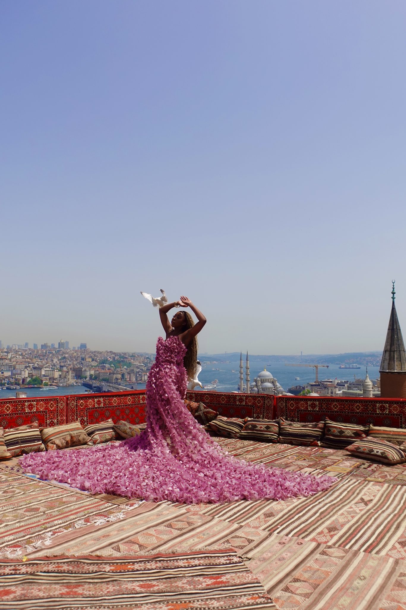Black girl wearing ruffled long dress on the rooftop for Istanbul photo shoot on a terrace