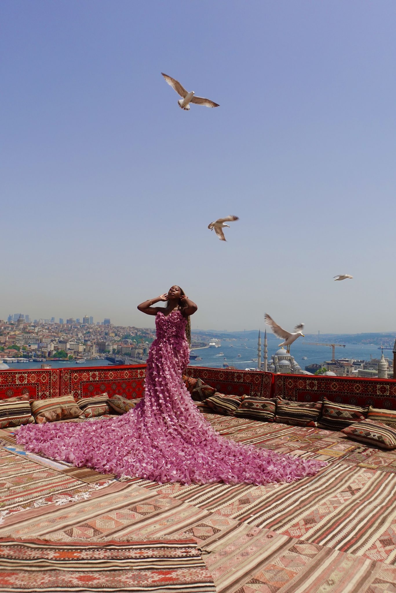 Black girl wearing ruffled long dress on the rooftop for Istanbul photo shoot on a terrace