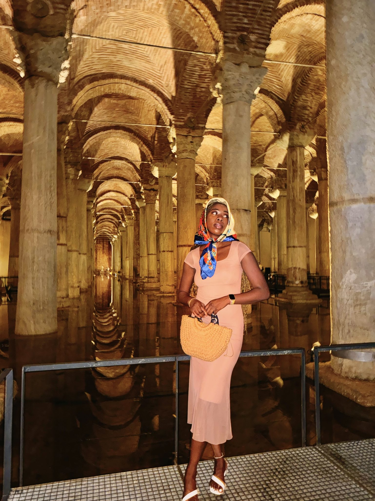 Girl wearing colorful scarf, holding a bag, standing in a cave, and Istanbul Turkey