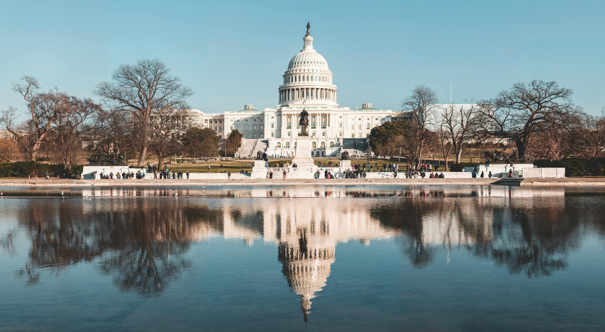 Stunning reflection of the United States Capitol in a tranquil pool on a clear autumn day.