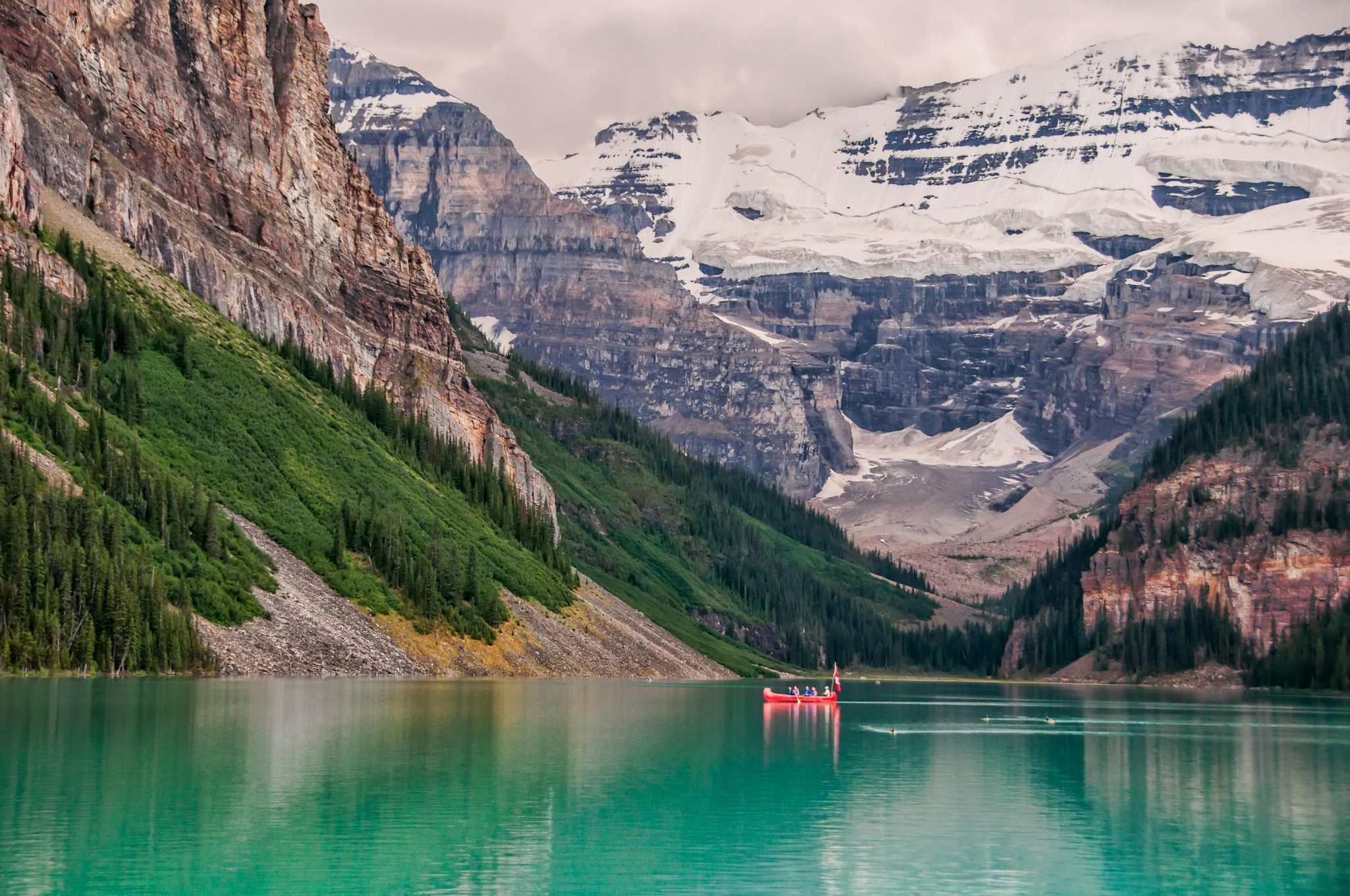 Picturesque canoeing at Lake Louise, surrounded by stunning Rocky Mountains.