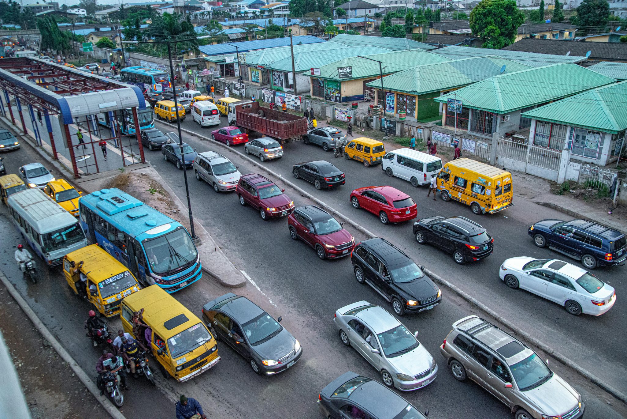 Aerial view of traffic congestion in a busy urban area with buses and cars.