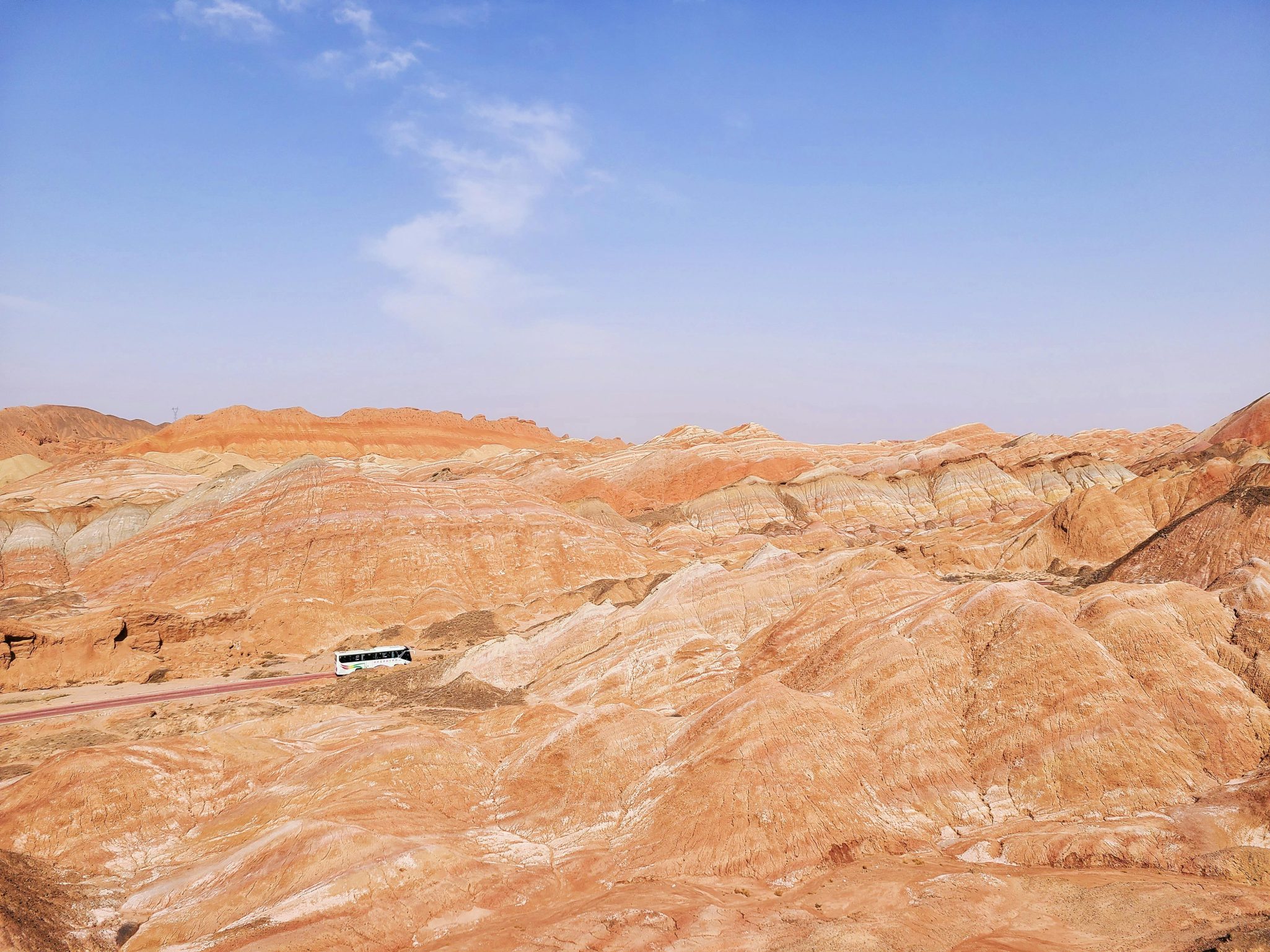 A breathtaking view of colorful rock formations in a desert landscape under a clear blue sky.